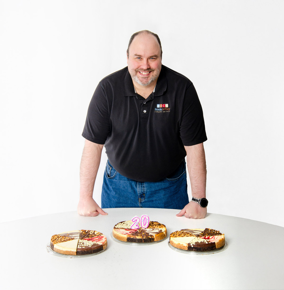 Brian Lane with 3 assorted Cheesecakes on a table in front of him